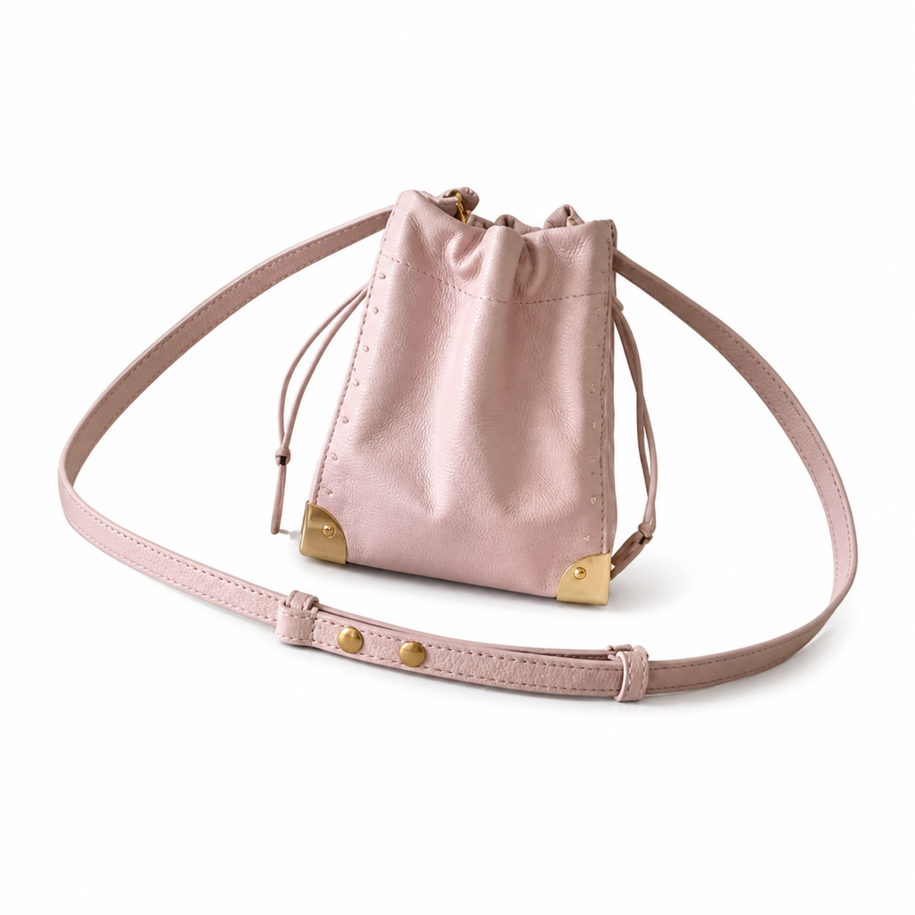 Louis Vuitton pink Monogram Empreinte leather drawstring bucket bag with gold corner studs and adjustable crossbody strap